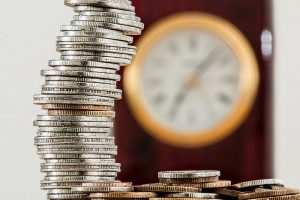 Coins stacked high illustrating cost reduction