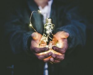Person holds a lightbulb